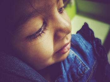 Close-up high angle view of cute girl looking away at home