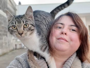 Portrait of cat and woman at home