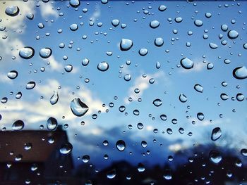 Full frame shot of raindrops on glass window