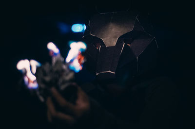 Close-up of hand holding illuminated lights