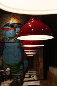 Illuminated lanterns hanging on table in restaurant