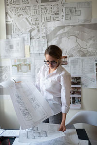 Full length of a woman working on table