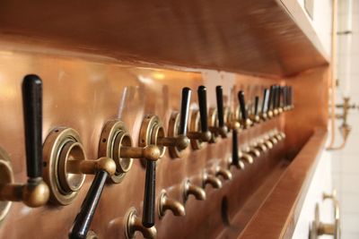 Close-up of beer taps in distillery