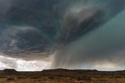 Scenic view of storm clouds over land