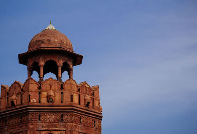 Low angle view of historic building against blue sky