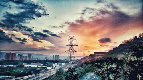 View of cityscape against cloudy sky