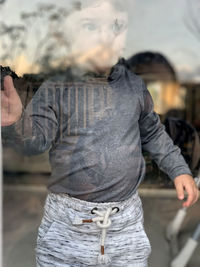 Midsection of man holding camera while standing outdoors