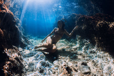 Low section of woman swimming in sea