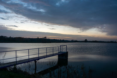 Dark evening clouds over the lake with a pier