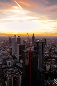 Aerial view of buildings in city during sunset