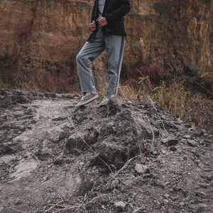 Low section of man standing on land