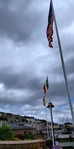 Low angle view of flags on building against sky