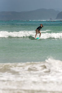 Man in sea against sky