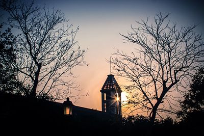 Low angle view of bare trees against sky
