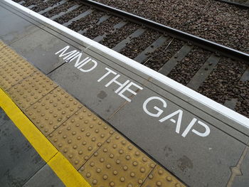 High angle view of text on railroad station platform