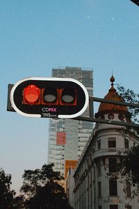 Low angle view of road sign against building
