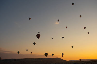 Low angle view of hot air balloons against sky during sunset