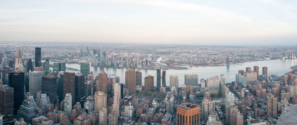 Aerial view of modern buildings in city against sky