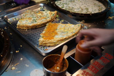 Cropped image of market vendor selling street food at night