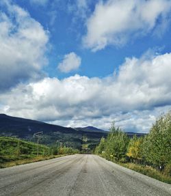 Empty road along landscape against sky