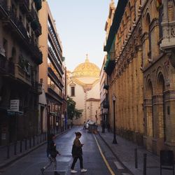 Man walking on road in city