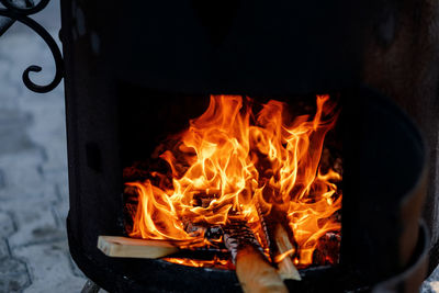 Open fire on wood in a large cauldron for cooking pilaf