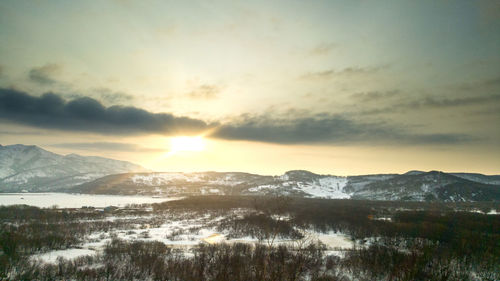 Scenic view of snowcapped mountains against sky during sunset