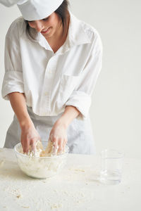 Midsection of man preparing food on table