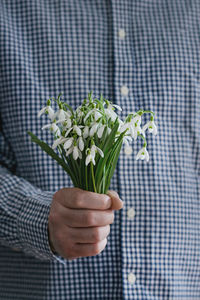 Close-up of hand holding flower bouquet