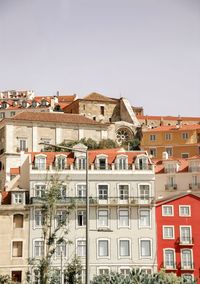 Low angle view of buildings in town against sky