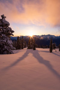 Scenic view of snowcapped landscape against sky during sunset