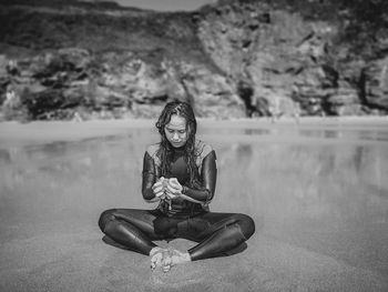 Portrait of woman sitting on sand