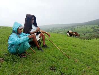 Horses on field against sky