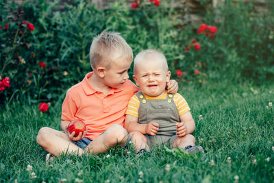 Full length of a baby girl sitting on grass