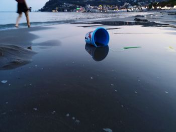 Reflection of man on sea water