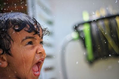 Close-up of a smiling young woman in water