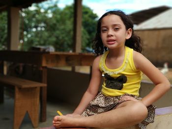 Portrait of girl on retaining wall