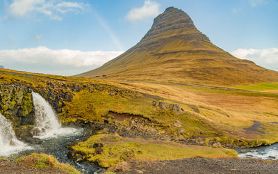 Scenic view of waterfall against sky