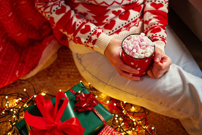 Midsection of woman holding christmas decoration