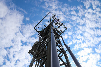 Low angle view of communications tower against sky