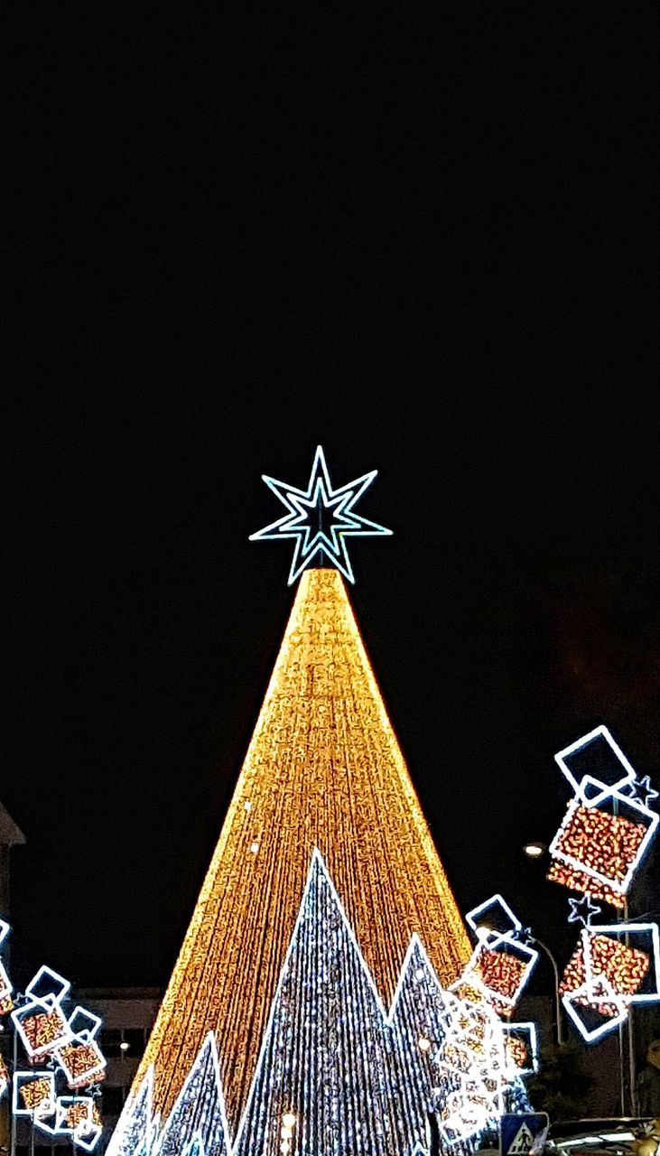 LOW ANGLE VIEW OF CHRISTMAS TREE AGAINST SKY DURING NIGHT