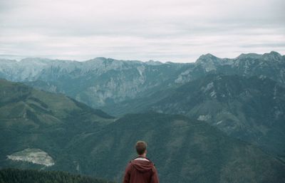 Rear view of woman standing on mountain