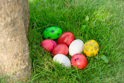 High angle view of multi colored eggs on field