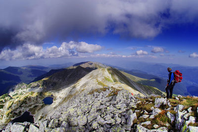 Man standing by mountains against sky