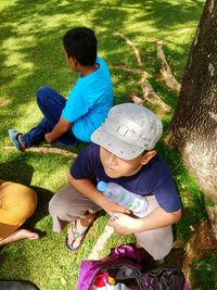 High angle view of siblings playing on grass