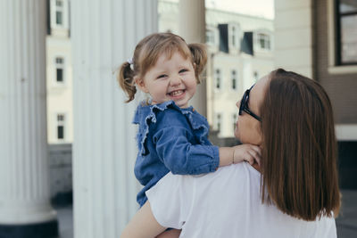 Portrait of mother and daughter outdoors