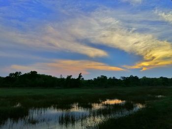 Scenic view of lake against sky during sunset