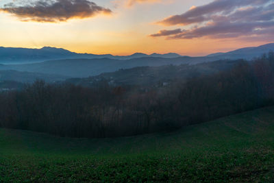 Scenic view of field against sky during sunset