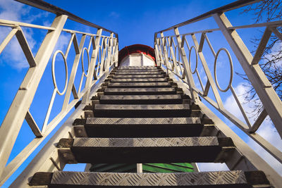 Low angle view of staircase against blue sky