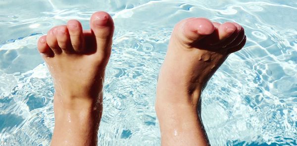 Low section of woman swimming in pool